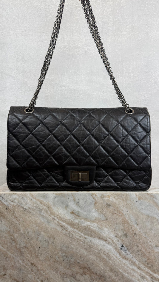 Black quilted handbag with chain strap Chanel reissue 2.77